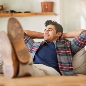 Man happily relaxing on the couch