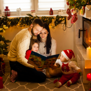 Family reading a book together during the holidays